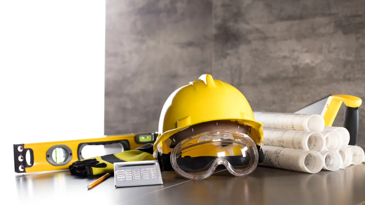 Contractor safety gear, plans, level, and calculator for business setup